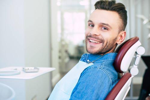 Man smiling in dental chair, wilmington de